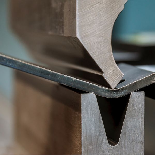 bending-sheet-metal-with-hydraulic-machine-factory-closeup